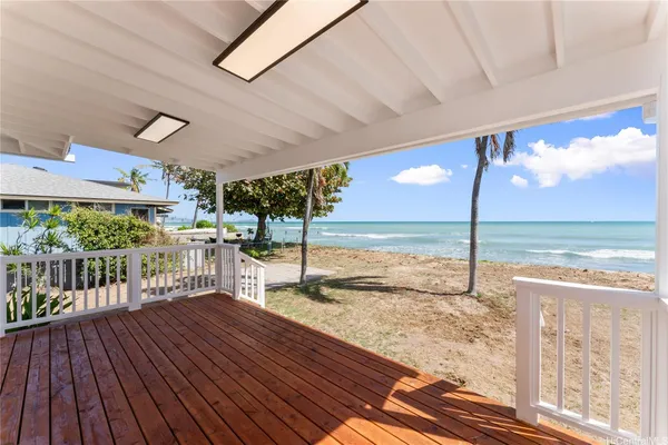 a view of a balcony with floor to ceiling windows wooden floor and city view