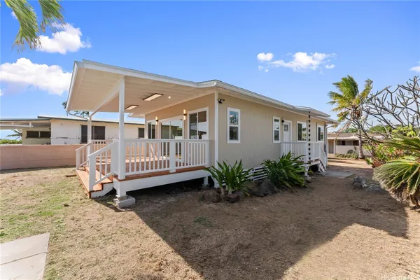 a view of a house with a wooden deck