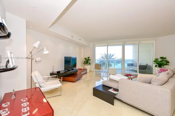 a living room with furniture wooden floor and a large window