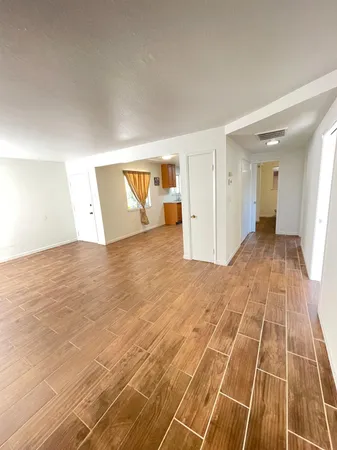 a view of a livingroom with wooden floor and closet