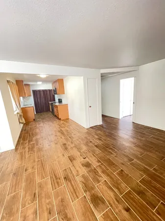 a big room with wooden floor and furniture