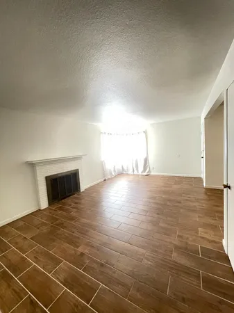 a view of a bedroom with a bed and a mirror