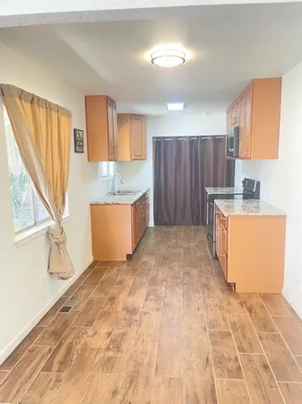 a view of a kitchen with a sink dishwasher and cabinets