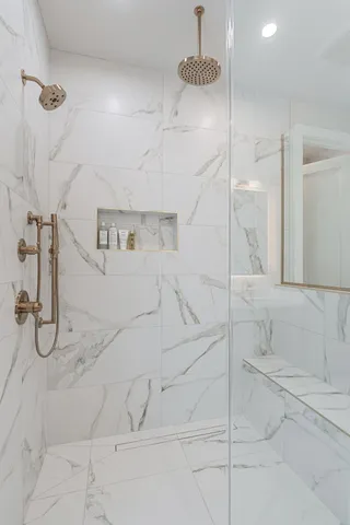 a bathroom with a shower and a glass door