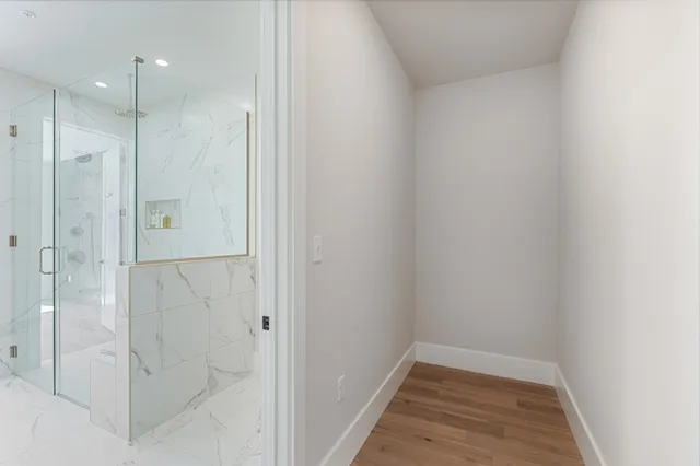 a bathroom with a double vanity sink mirror and shower