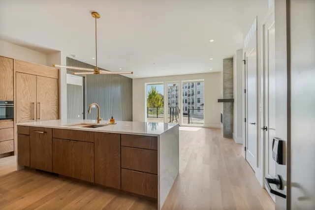 a view of a kitchen with a sink and wooden floor