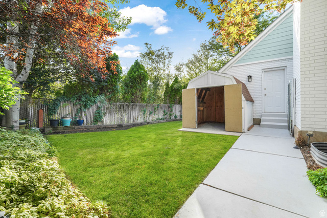 8965 Quail Run Drive Sandy, UT 84093 - Photo 27 of 56 Fenced backyard with a storage shed