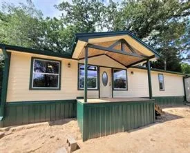 a view of a house with a small yard next to a yard
