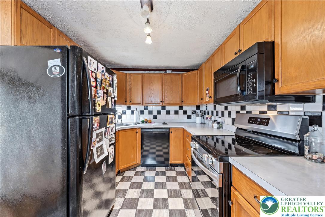 115 North Liberty Street Nazareth, PA 18064 - Photo 11 of 27 a kitchen with stainless steel appliances granite countertop a stove a sink and a microwave