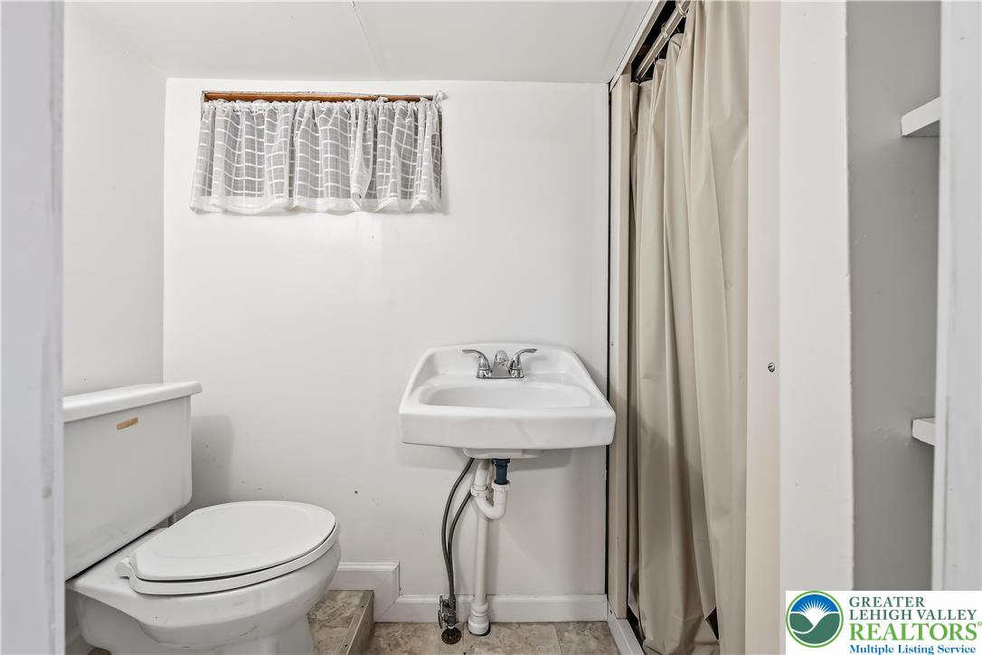 115 North Liberty Street Nazareth, PA 18064 - Photo 20 of 27 a bathroom with a sink a toilet and a mirror