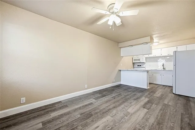 a view of kitchen with wooden floor and window