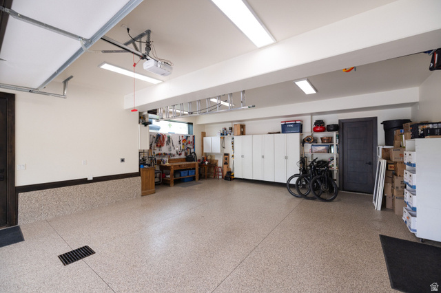 11547 Soaring Hawk Lane Hideout, UT 84036 - Photo 39 of 43 Spacious garage featuring a durable epoxy flooring system, overhead lighting, and extensive built-in cabinetry for organized storage