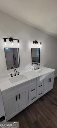 a bathroom with a double vanity sink and mirror
