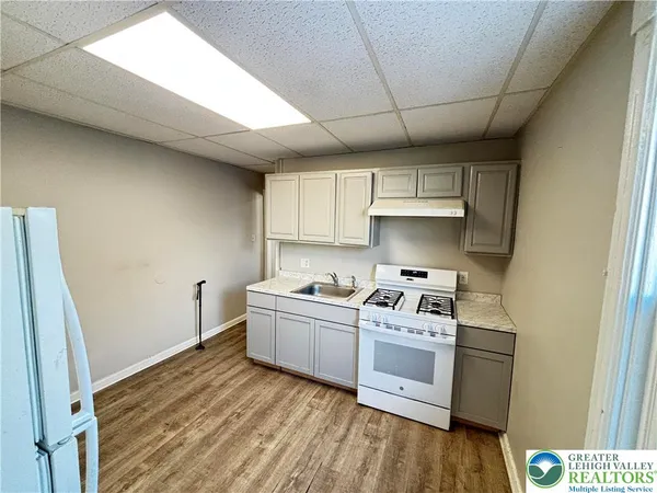 a kitchen with stainless steel appliances a stove a sink and a refrigerator