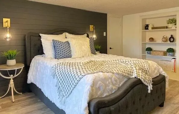 a bedroom with a bed and a closet with wooden floor