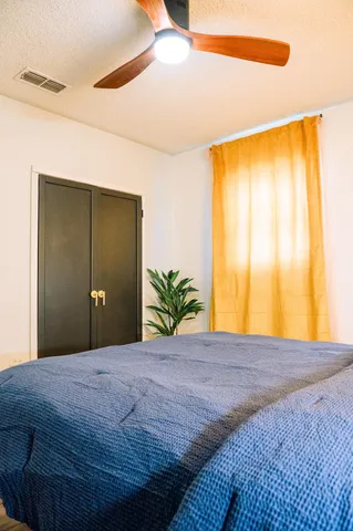 a bedroom with a bed and lamps