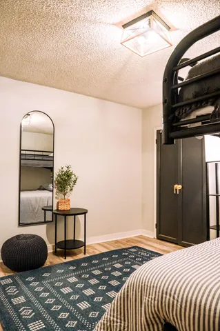 a bedroom with a bed and a painting on the wall