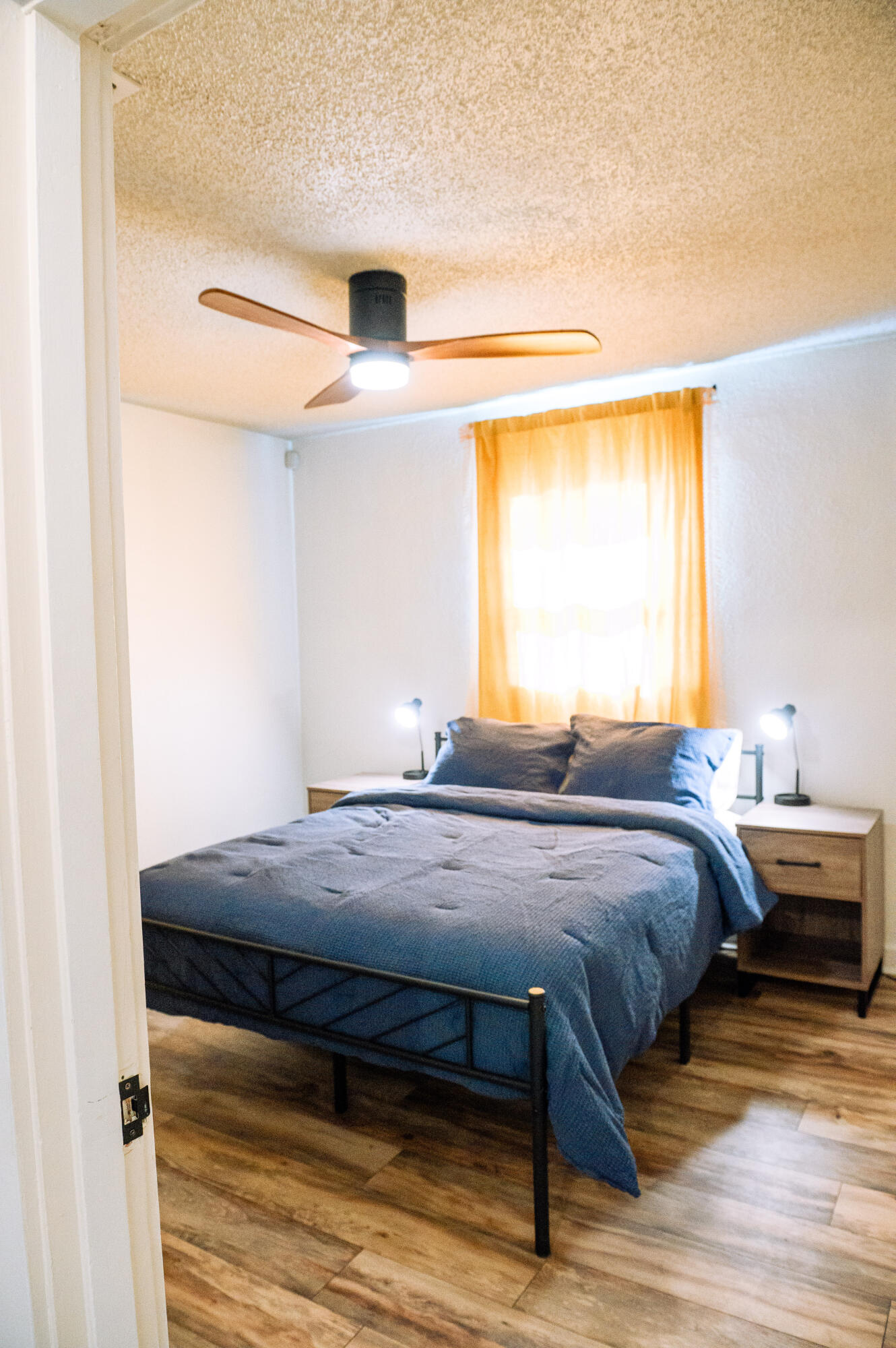 2436 24th Street, Unit FRONT Lubbock, TX 79411 - Photo 16 of 24 a bedroom with a bed and wooden floor