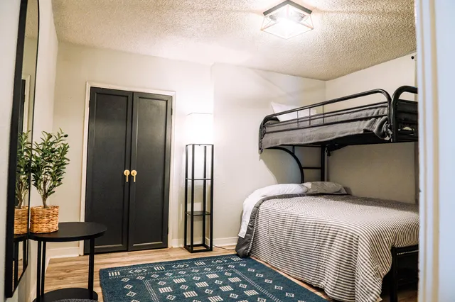 a bedroom with double bed and a potted plant