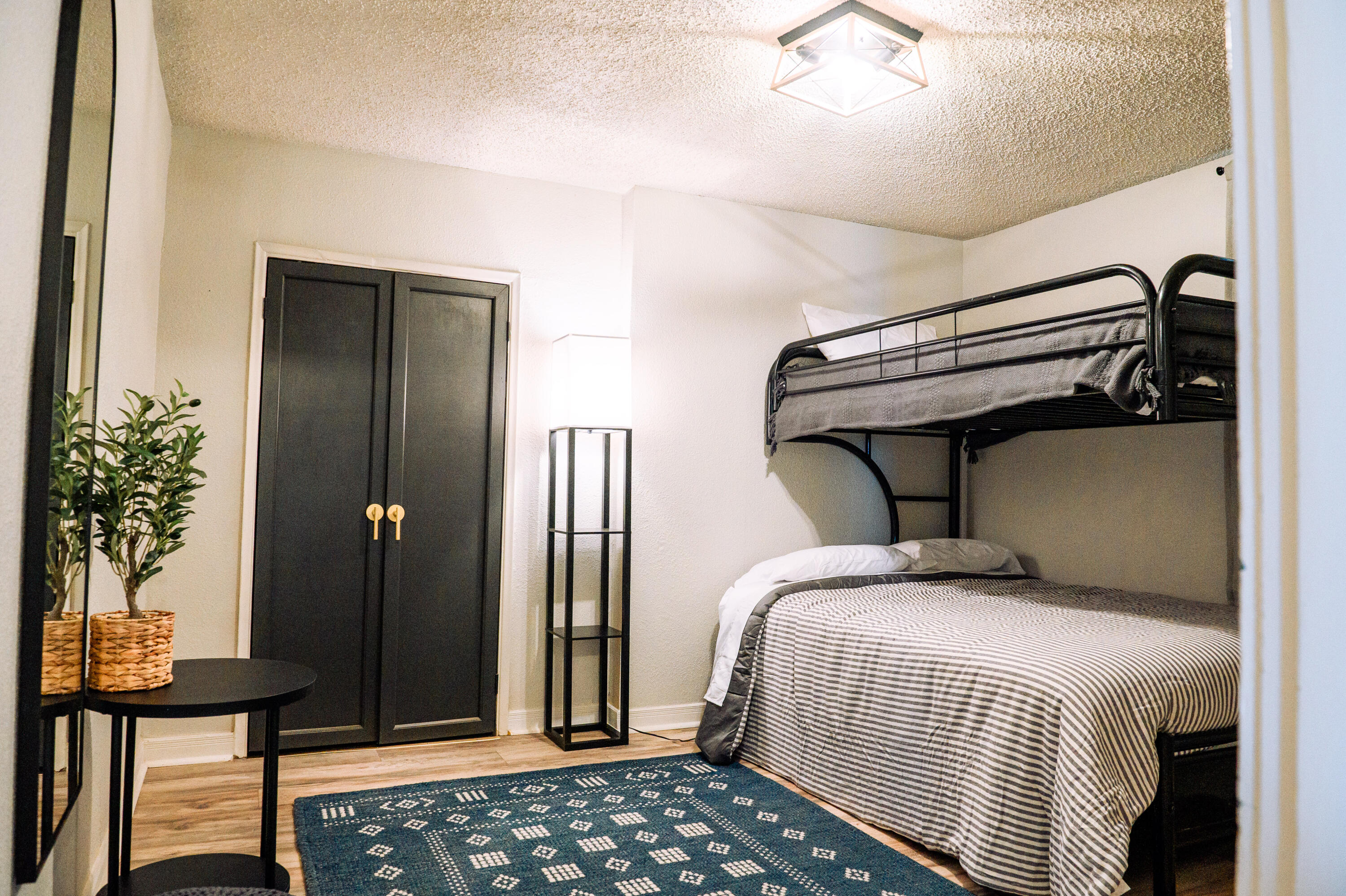 2436 24th Street, Unit FRONT Lubbock, TX 79411 - Photo 17 of 24 a bedroom with double bed and a potted plant