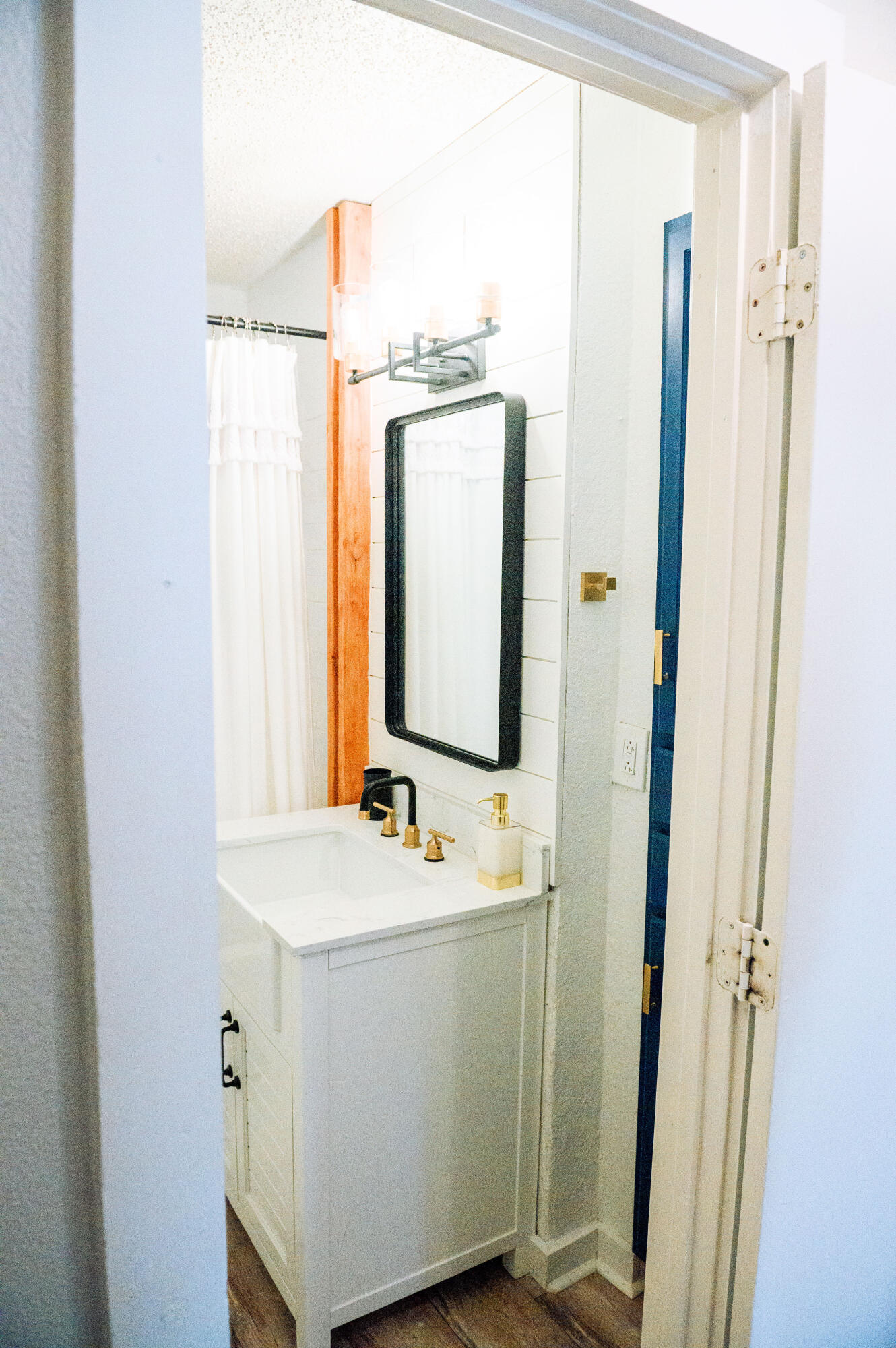 2436 24th Street, Unit FRONT Lubbock, TX 79411 - Photo 18 of 24 a bathroom with a sink and a mirror
