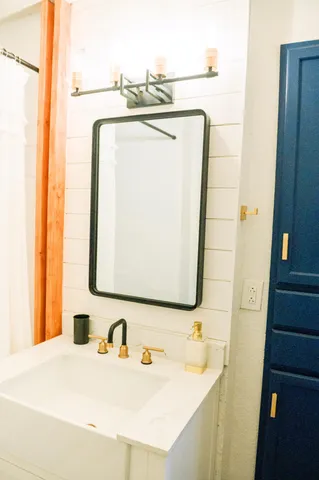 a bathroom with a sink and a mirror