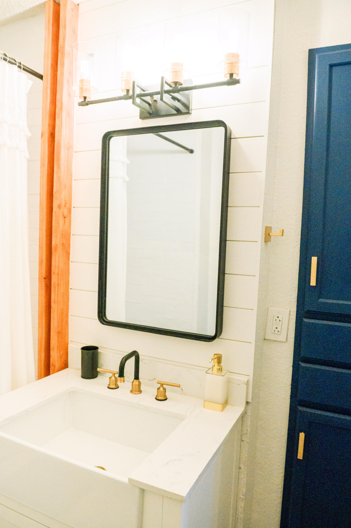 2436 24th Street, Unit FRONT Lubbock, TX 79411 - Photo 20 of 24 a bathroom with a sink and a mirror