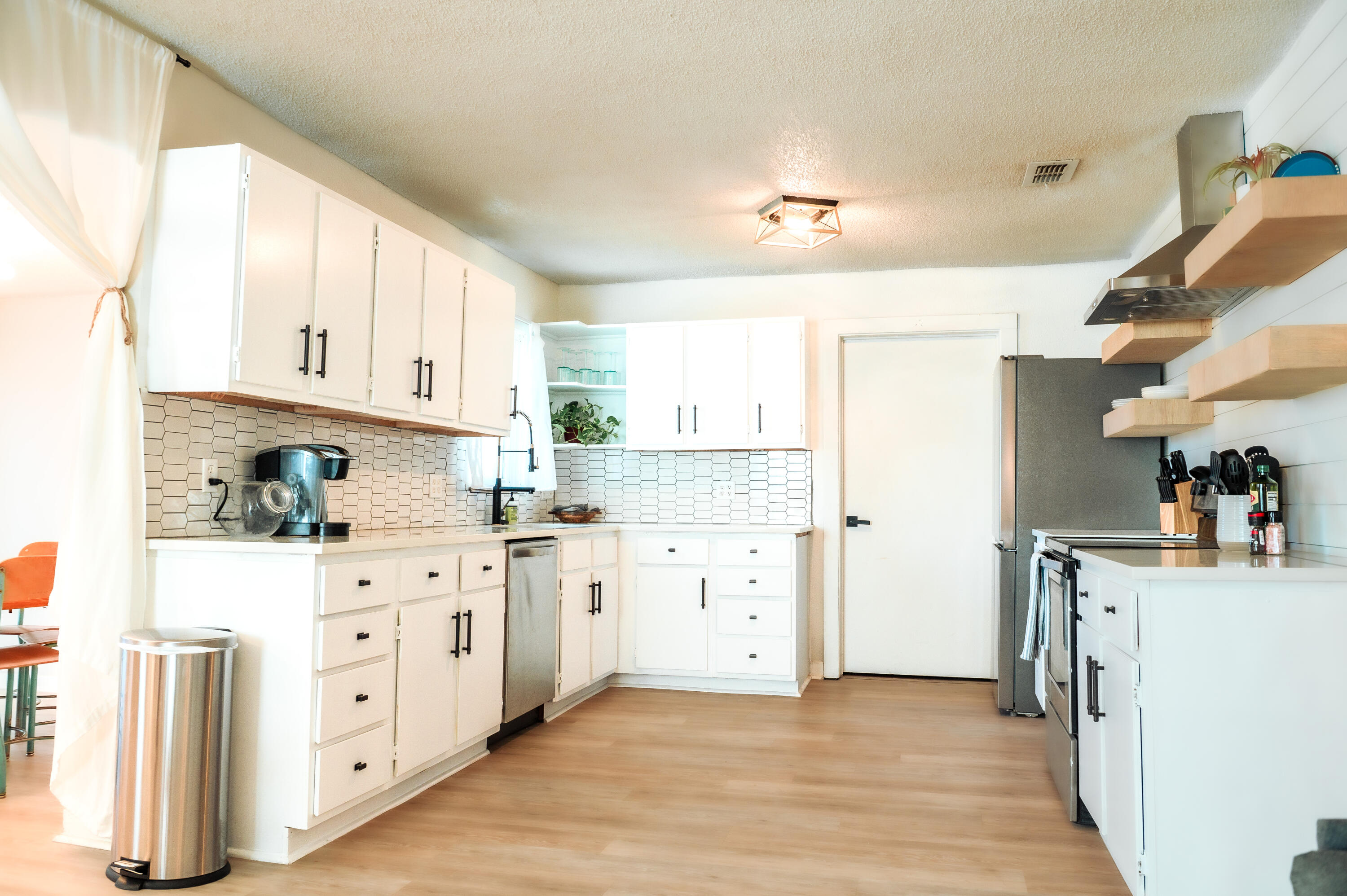2436 24th Street, Unit FRONT Lubbock, TX 79411 - Photo 3 of 24 a kitchen with stainless steel appliances a stove refrigerator sink and cabinets