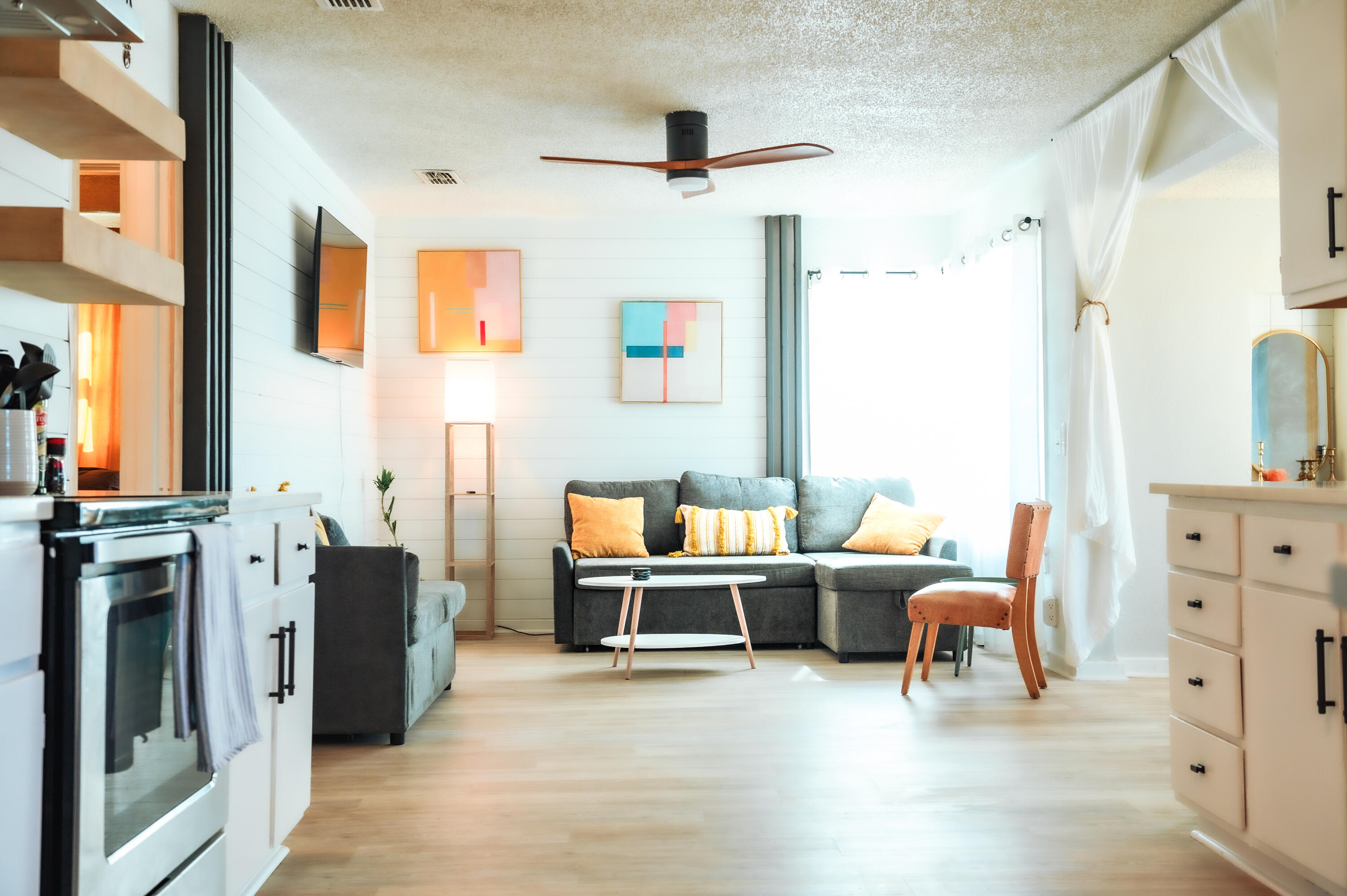 2436 24th Street, Unit FRONT Lubbock, TX 79411 - Photo 5 of 24 a living room with furniture a fireplace and a large window