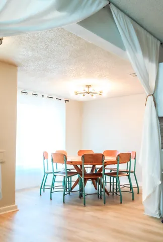 a dining room with furniture and wooden floor