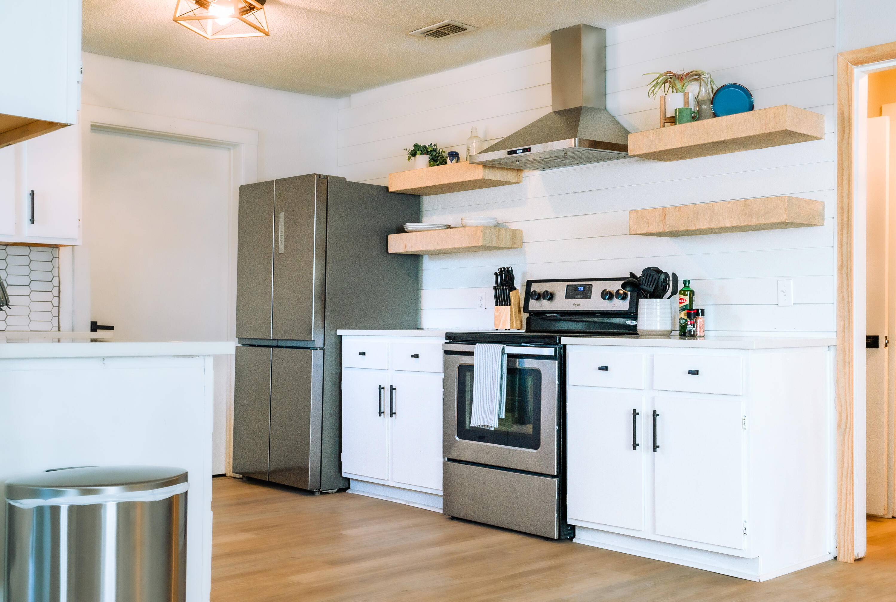 2436 24th Street, Unit FRONT Lubbock, TX 79411 - Photo 7 of 24 a kitchen with stainless steel appliances a refrigerator and a stove