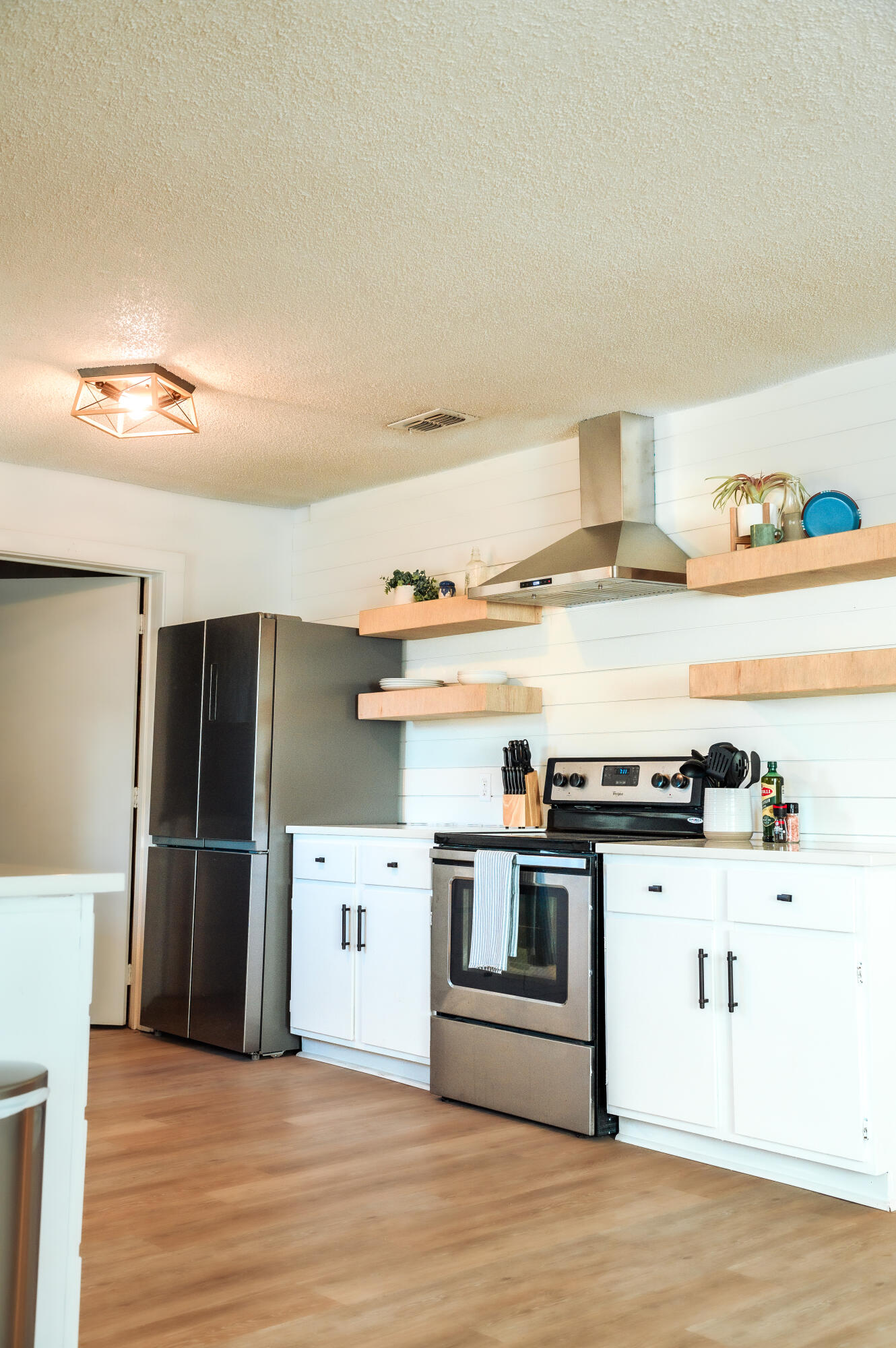 2436 24th Street, Unit FRONT Lubbock, TX 79411 - Photo 8 of 24 a kitchen with stainless steel appliances granite countertop a stove and a refrigerator