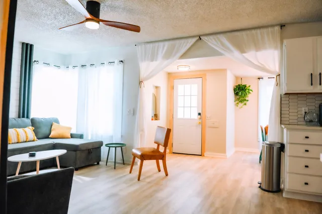 a living room with furniture and wooden floor