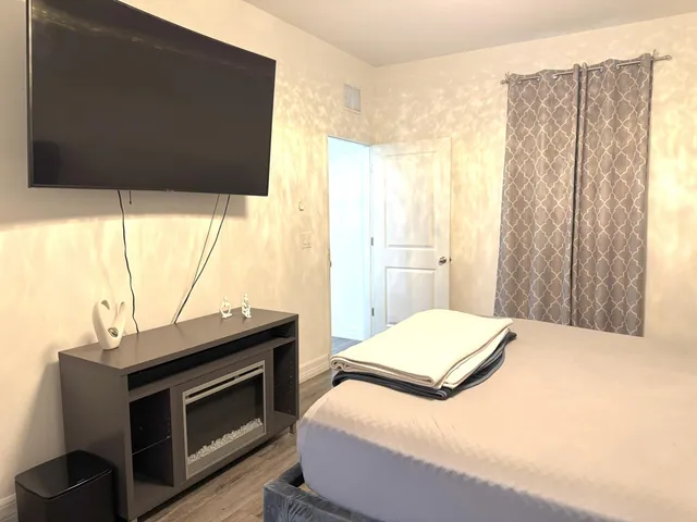 a bedroom with a bed and a flat tv screen