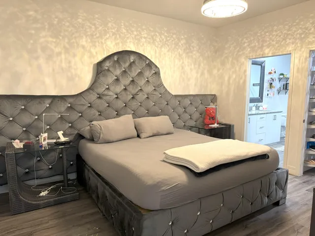 a bedroom with a bed and a chandelier