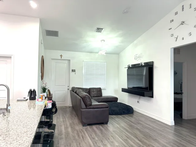 a living room with furniture and a flat screen tv