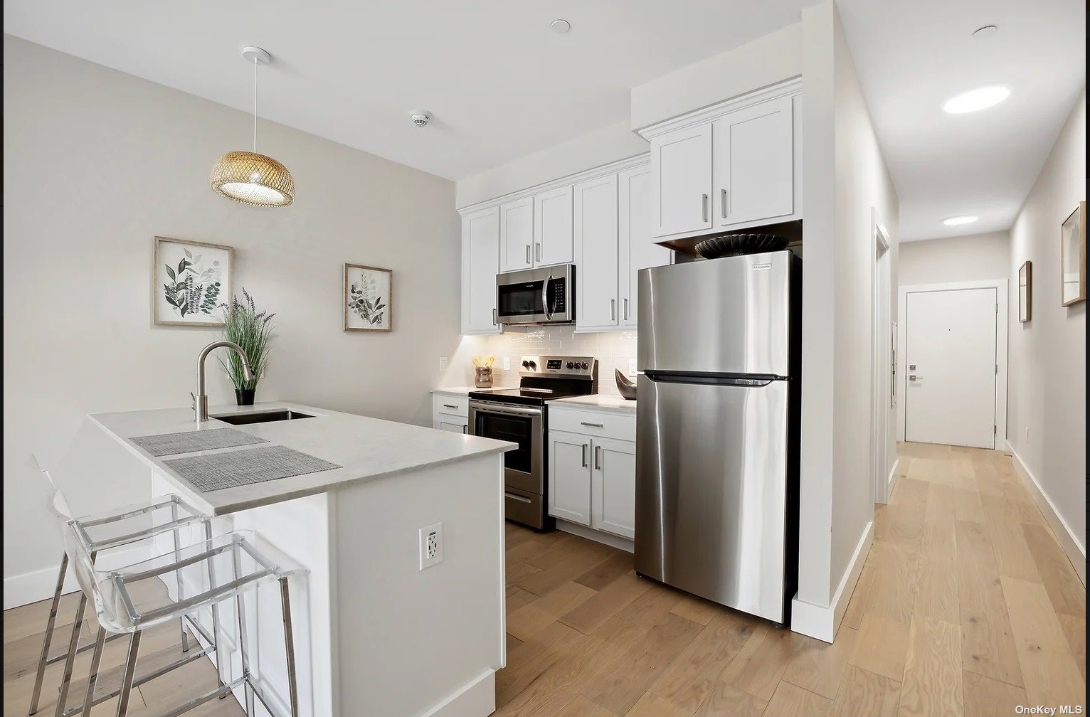 a kitchen with cabinets stainless steel appliances and a refrigerator