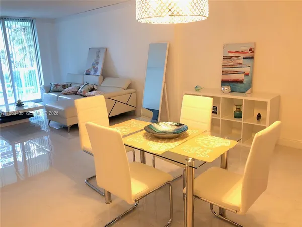 a kitchen with appliances a refrigerator a sink and cabinets