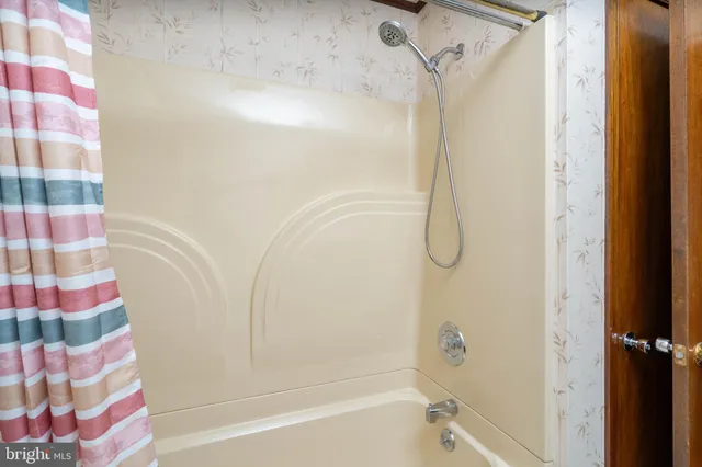 a bathroom with a bathtub and a shower