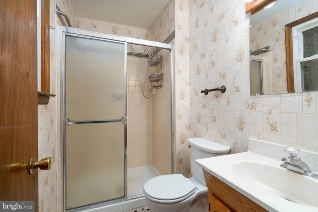 a white toilet sitting next to a bathroom sink