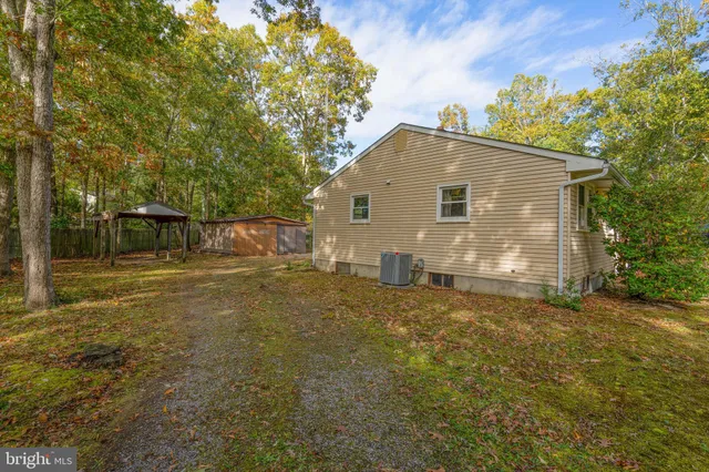 a view of backyard of house with green space