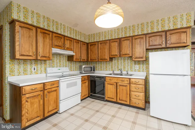 a kitchen with cabinets appliances and a window