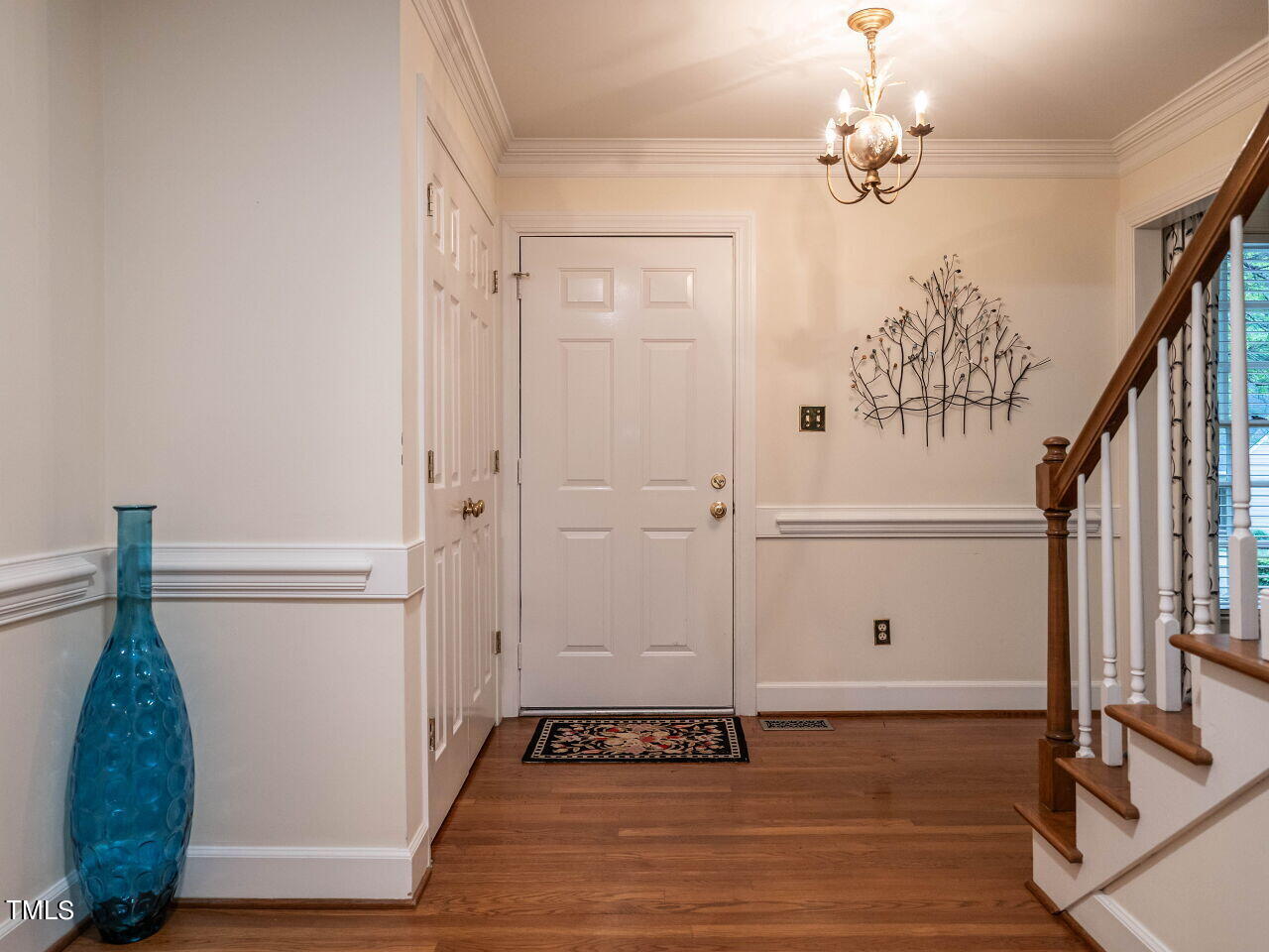 7805 Highlandview Circle Raleigh, NC 27613 - Photo 5 of 33 a view of a hallway with wooden floor and staircase