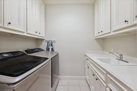 a kitchen with sink and cabinets