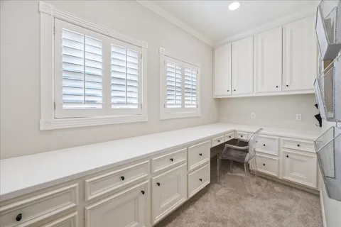 a view of a kitchen with white cabinets