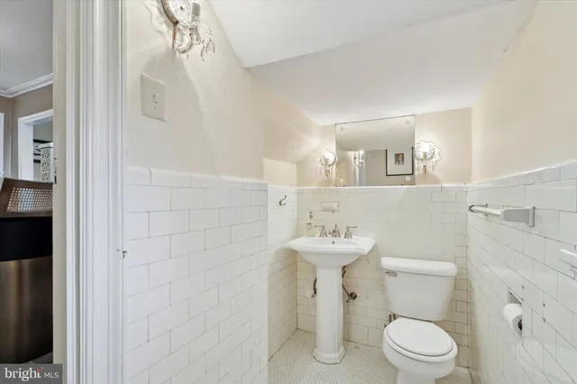 a white toilet sitting next to a bathroom sink