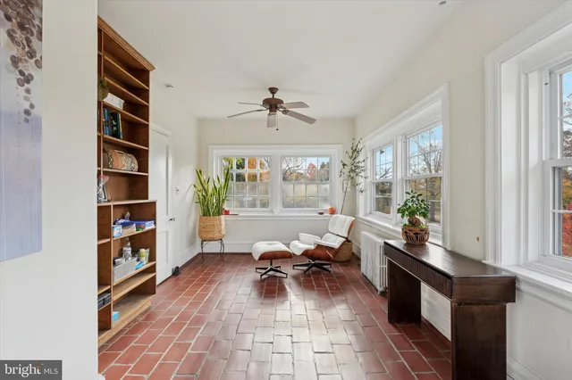 a living room with furniture and a book shelf
