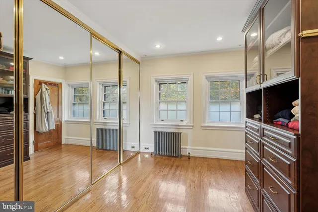 a living room with stainless steel appliances furniture and a flat screen tv