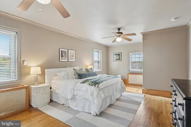 a spacious bedroom with a bed and a chandelier