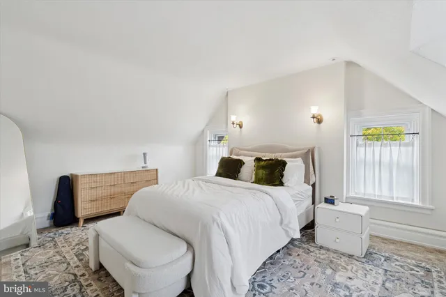 a bedroom with a bed and a couch